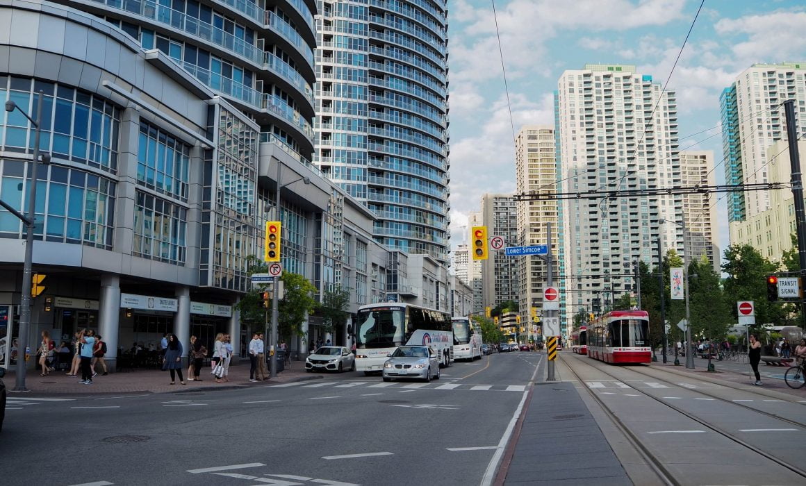 Busy street with cyclist, pedestrians and cars lawyer toronto